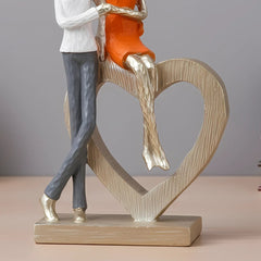 Romantic Couple with Heart Sculpture