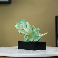 Green and Gold Feather Sculpture with Artistic Flow Design