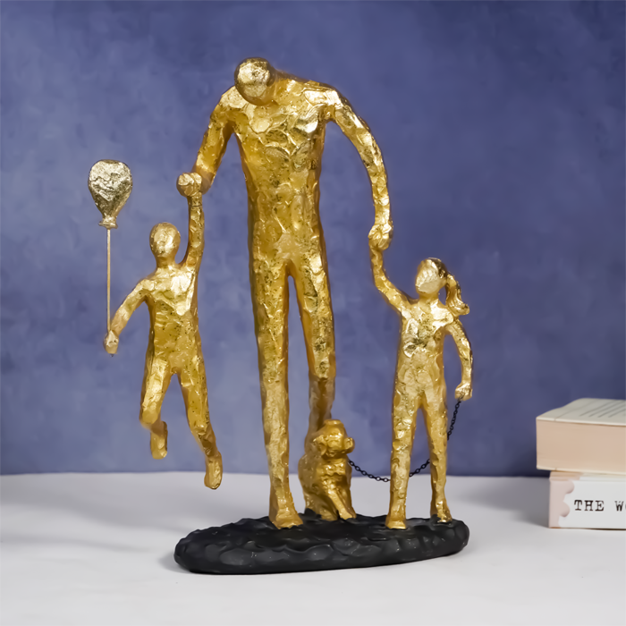 Gold Family Sculpture with Balloon - Joyful Moments in Art