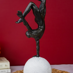 Black Gymnast Sculpture on White Sphere