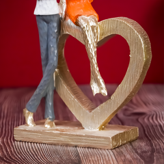 Romantic Couple with Heart Sculpture