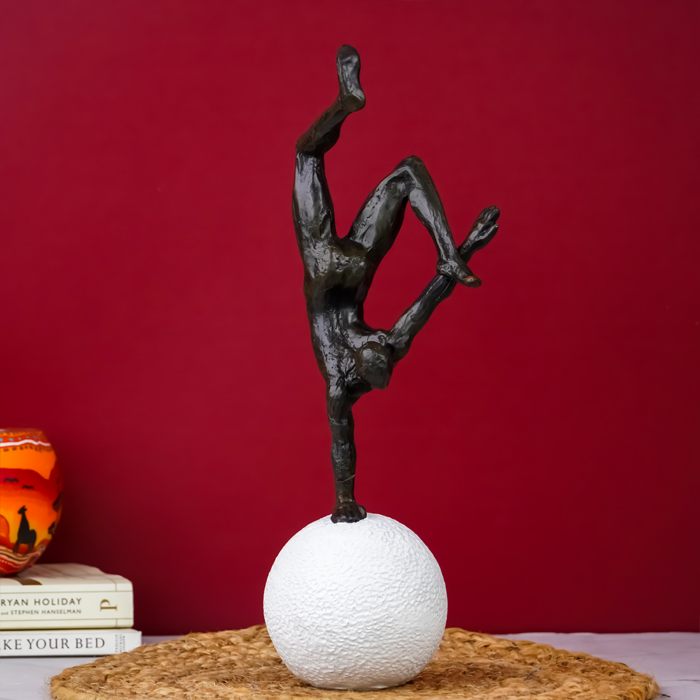 Black Gymnast Sculpture on White Sphere