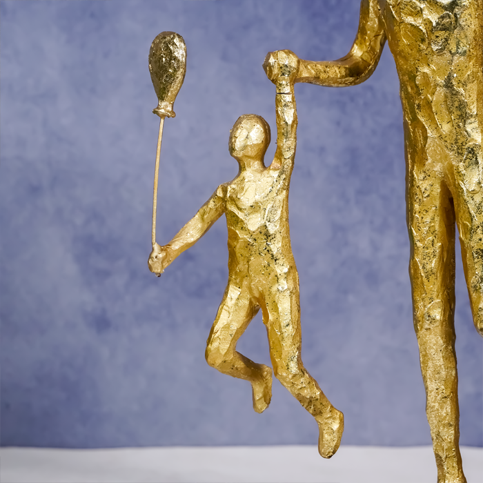 Gold Family Sculpture with Balloon - Joyful Moments in Art