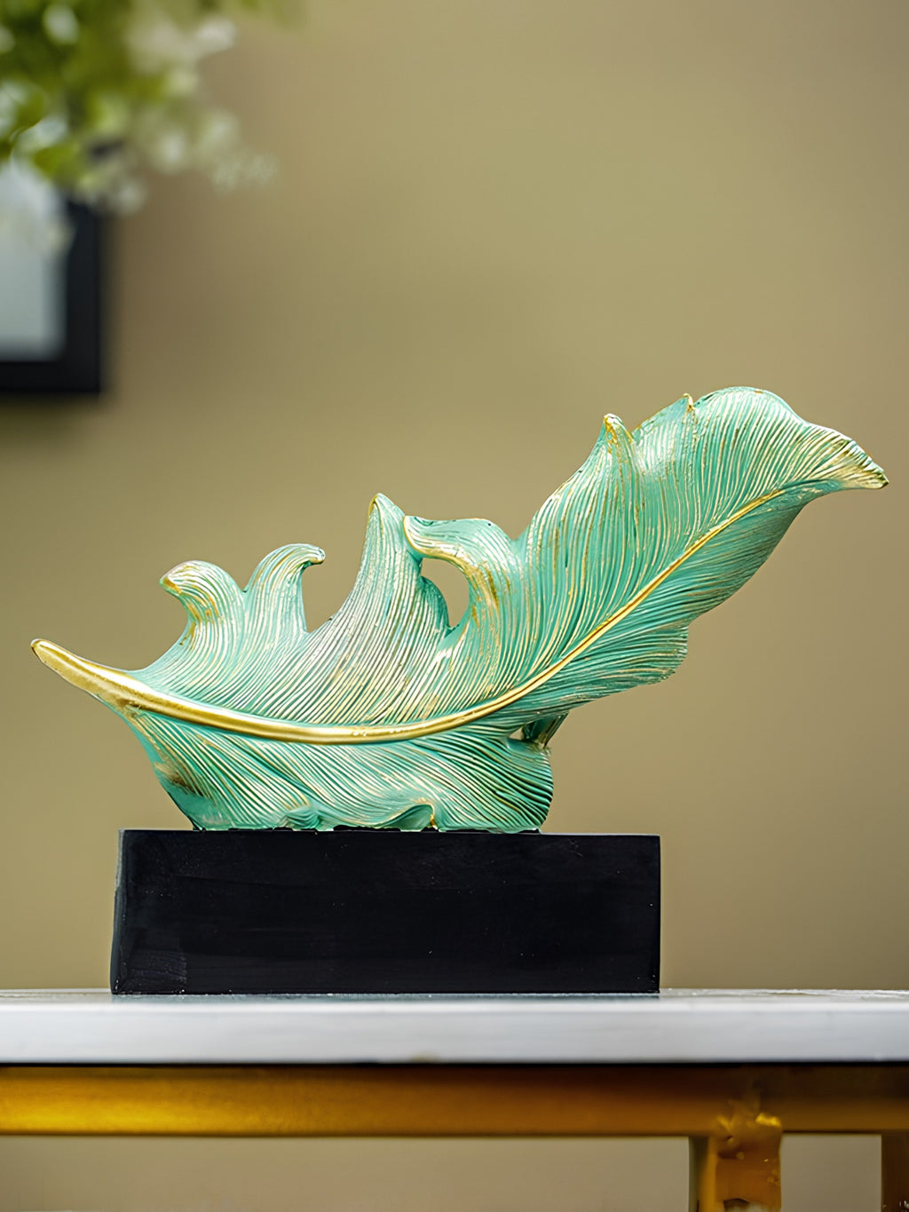 Green and Gold Feather Sculpture with Artistic Flow Design