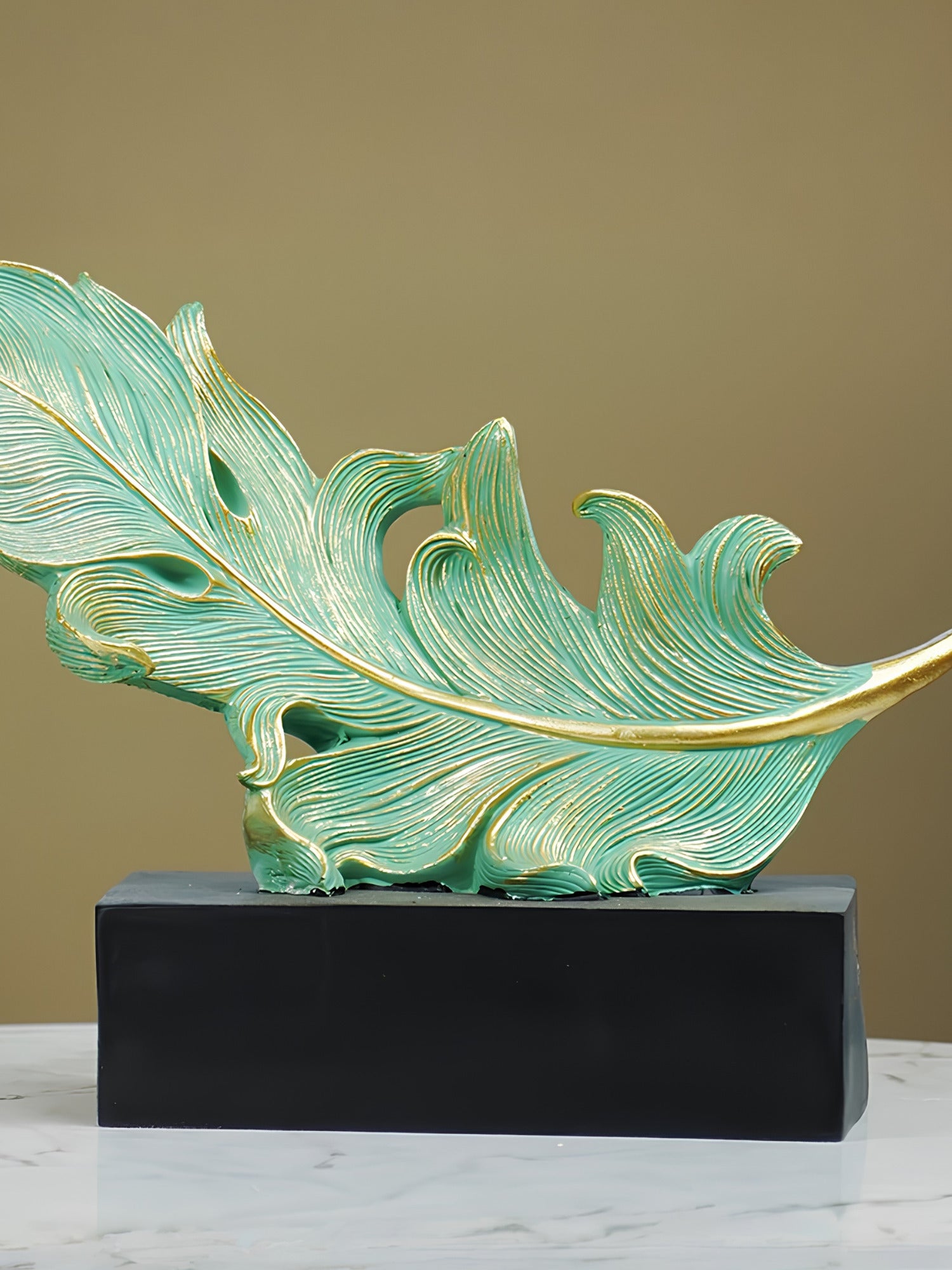 Green and Gold Feather Sculpture with Artistic Flow Design