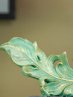 Green and Gold Feather Sculpture with Artistic Flow Design