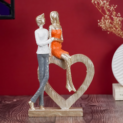 Romantic Couple with Heart Sculpture