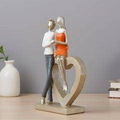 Romantic Couple with Heart Sculpture