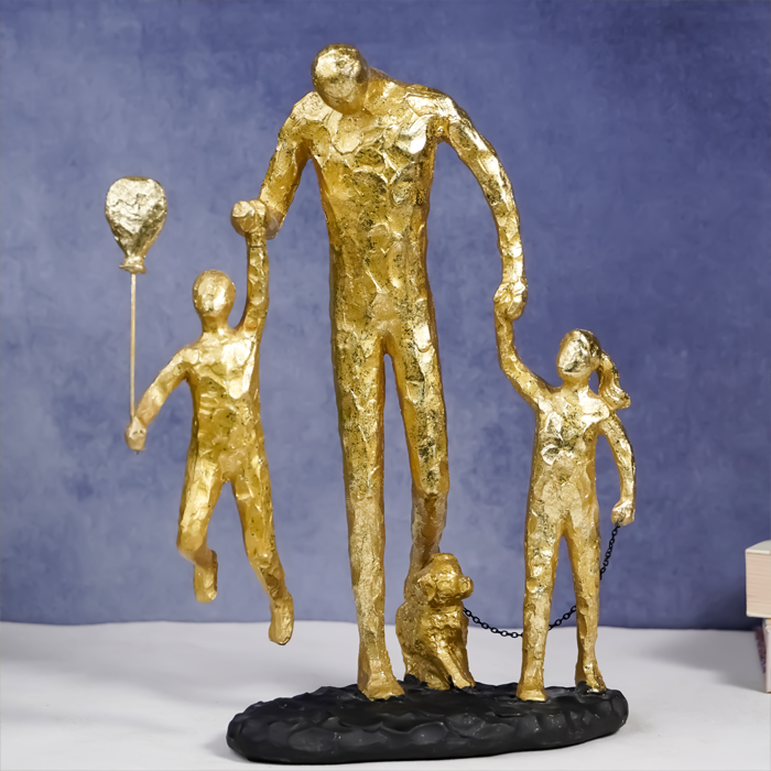 Gold Family Sculpture with Balloon - Joyful Moments in Art