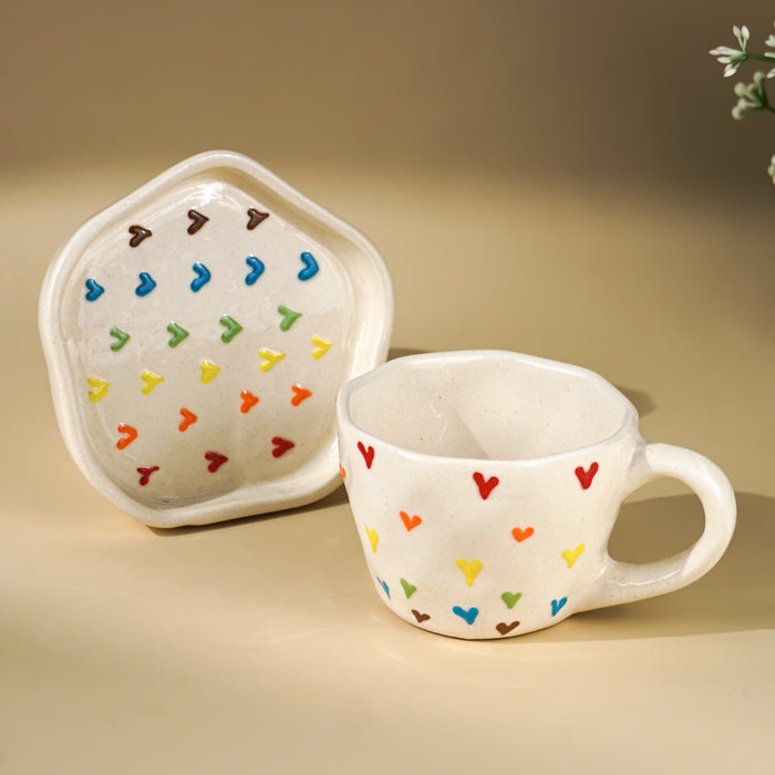 Cream Ceramic Cup with Multicolor Heart Embossed Design