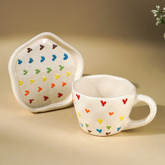 Cream Ceramic Cup with Multicolor Heart Embossed Design