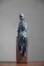 Seated Woman Sculpture on Wood Textured Pedestal – Forward-Facing Figure Statue