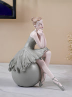 Ballerina Figurine Sitting on Sphere - The Golden Theory