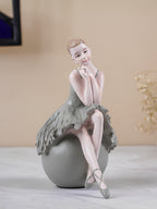 Ballerina Figurine Sitting on Sphere - The Golden Theory