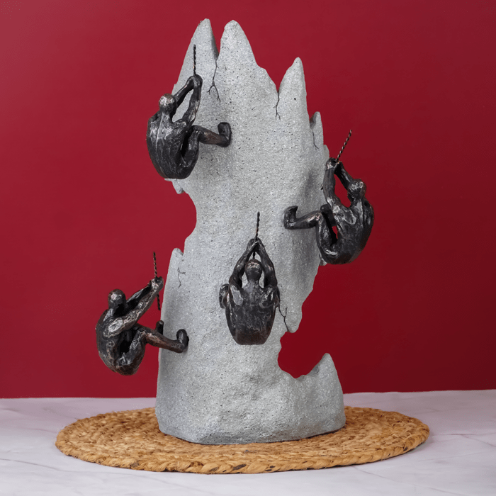 Black Climbers on Gray Rock Sculpture - The Golden Theory