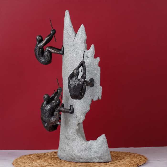 Black Climbers on Gray Rock Sculpture - The Golden Theory