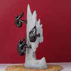 Black Climbers on Gray Rock Sculpture - The Golden Theory