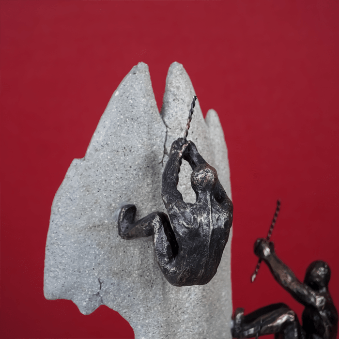 Black Climbers on Gray Rock Sculpture - The Golden Theory