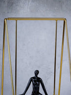 Black Figure on Gold Swing - The Golden Theory
