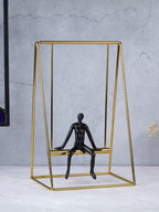 Black Figure on Gold Swing - The Golden Theory