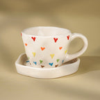 Cream Ceramic Cup with Multicolor Heart Embossed Design - The Golden Theory