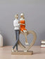 Romantic Couple with Heart Sculpture - The Golden Theory