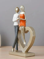 Romantic Couple with Heart Sculpture - The Golden Theory