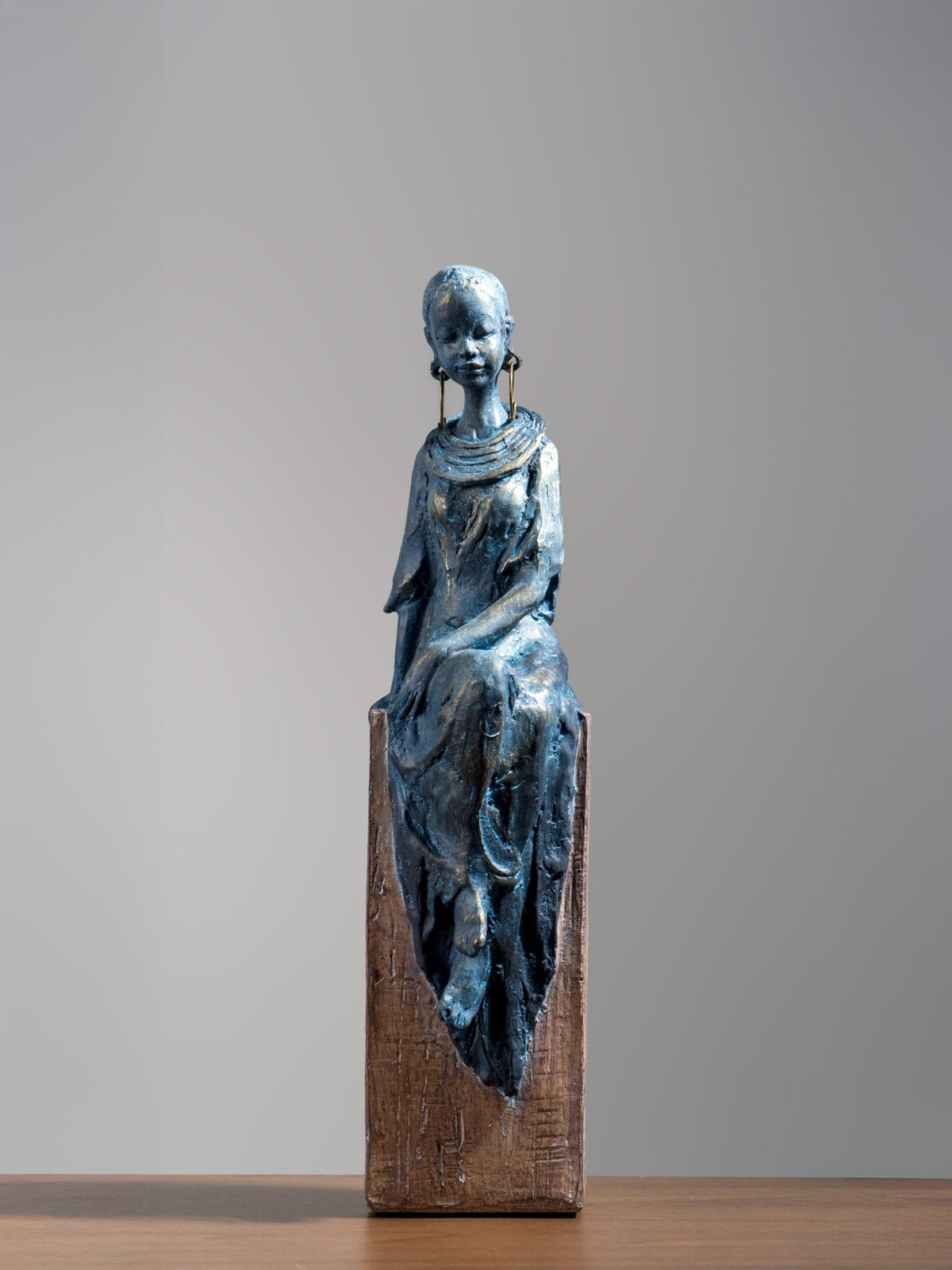 Seated Woman Sculpture on Wood Textured Pedestal – Forward-Facing Figure Statue - The Golden Theory Main image