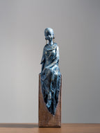 Seated Woman Sculpture on Wood Textured Pedestal – Forward-Facing Figure Statue - The Golden Theory