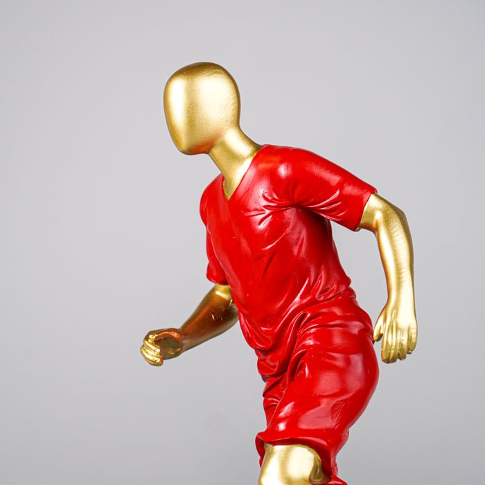 Soccer Player Sculpture in Red Uniform - The Golden Theory
