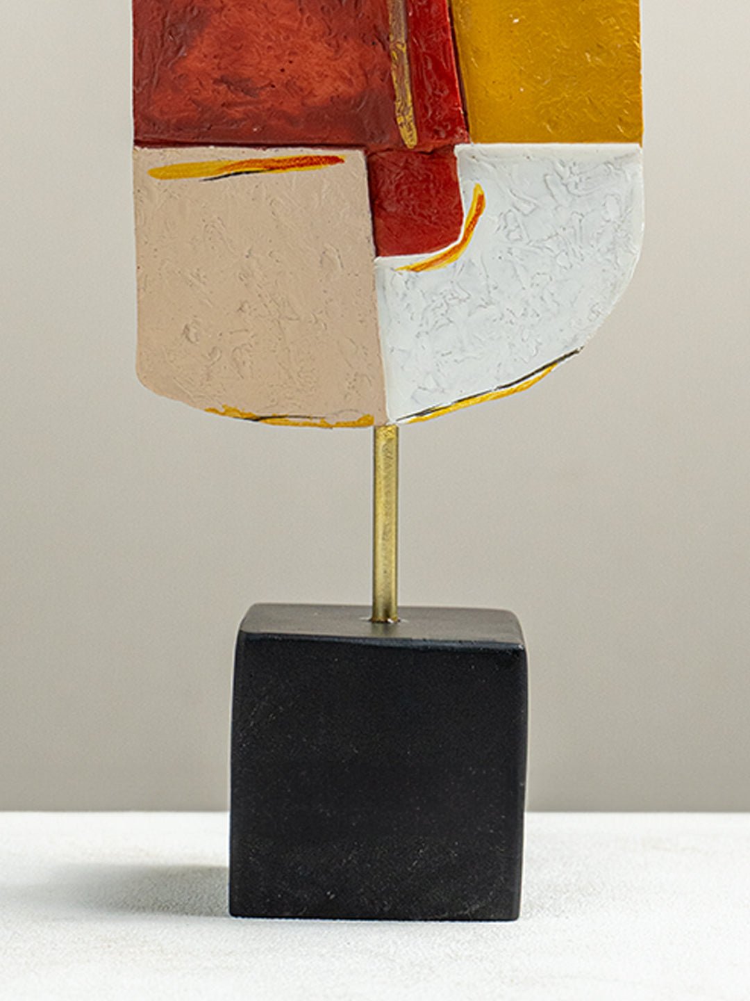 Vibrant Abstract Face Sculpture in Red, Yellow, and White - The Golden Theory