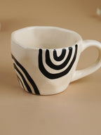 White Ceramic Mug with Hand-Painted Black Arch Design - The Golden Theory